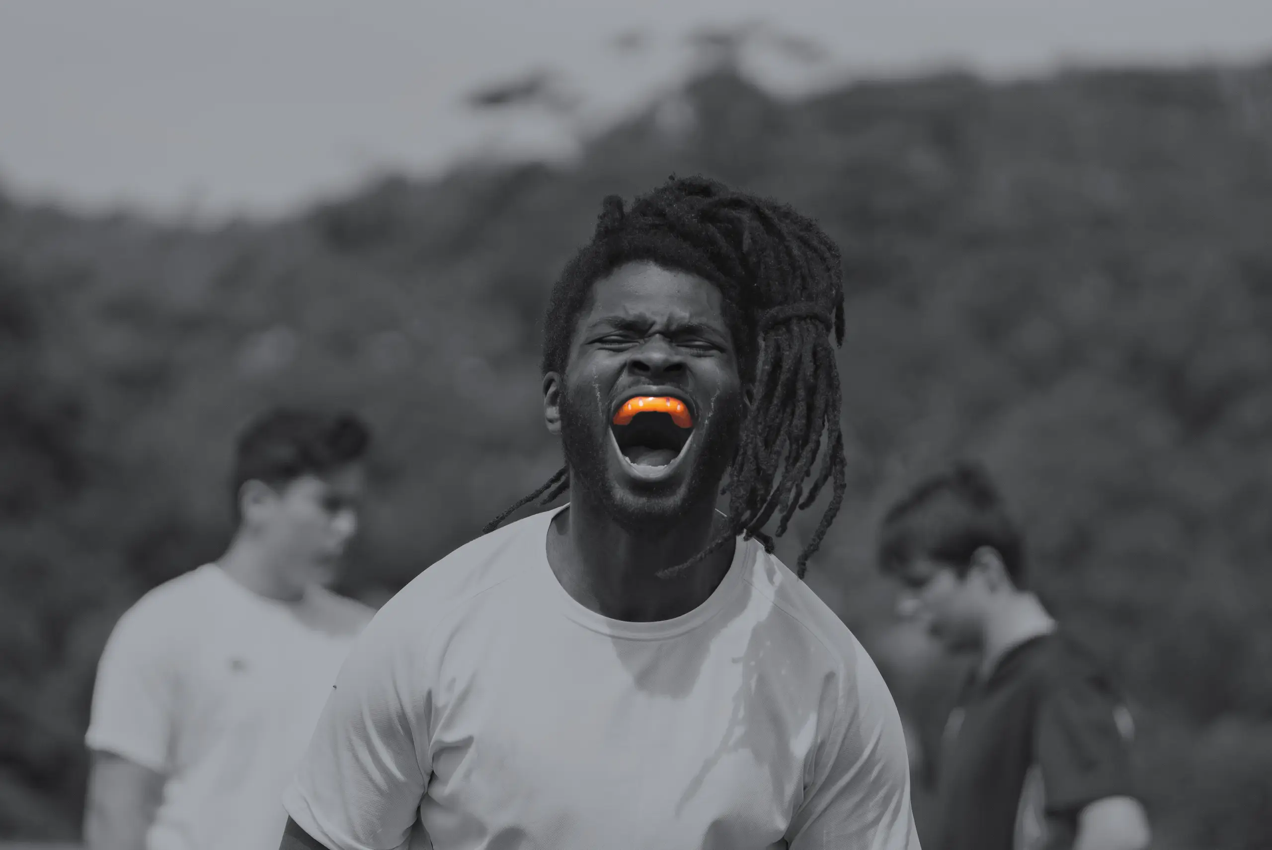 Passionate male sports person wearing an orange Neomorph Prodigy Mouthguard