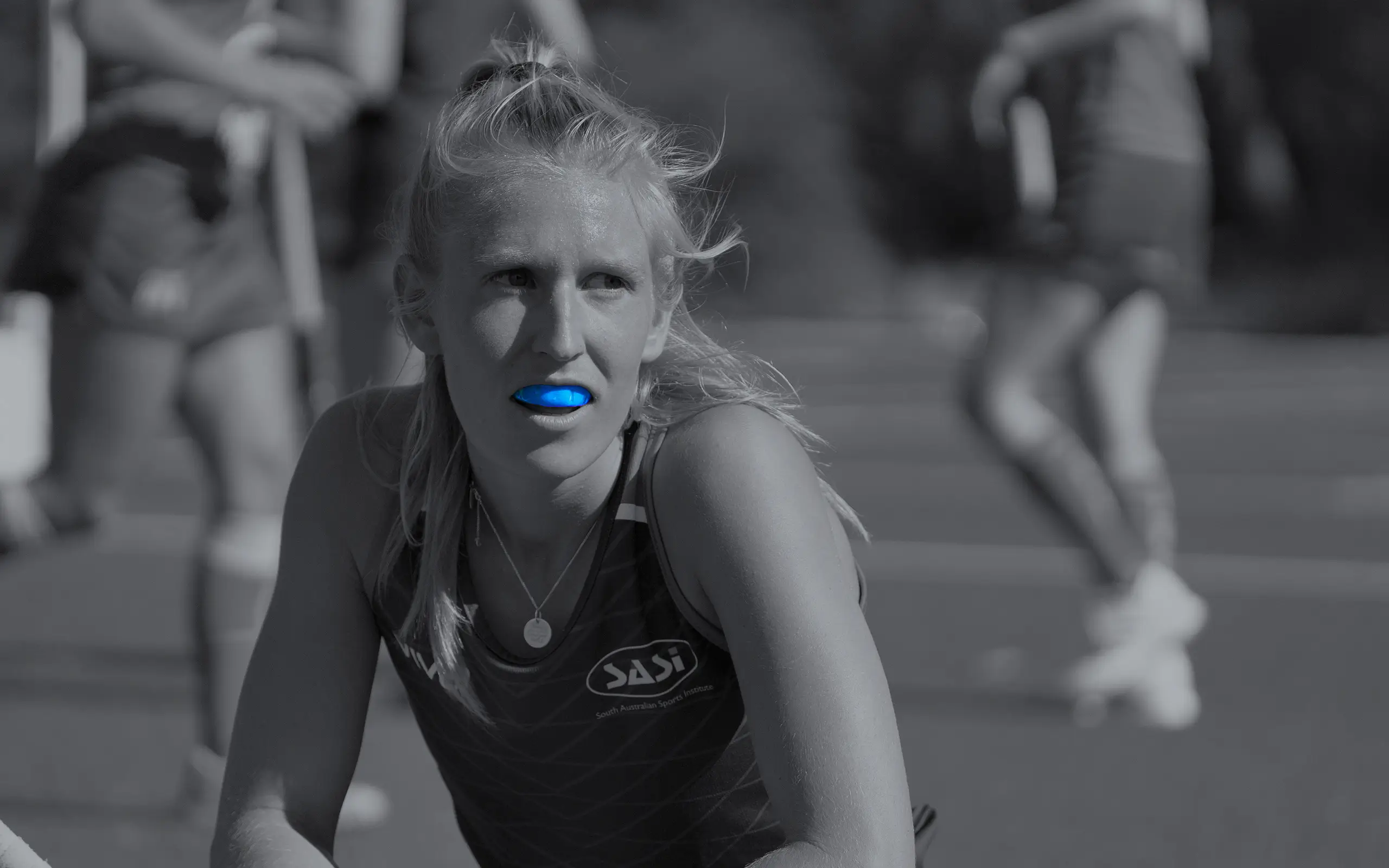 Female Hockey player wearing a blue Neomorph mouthguard