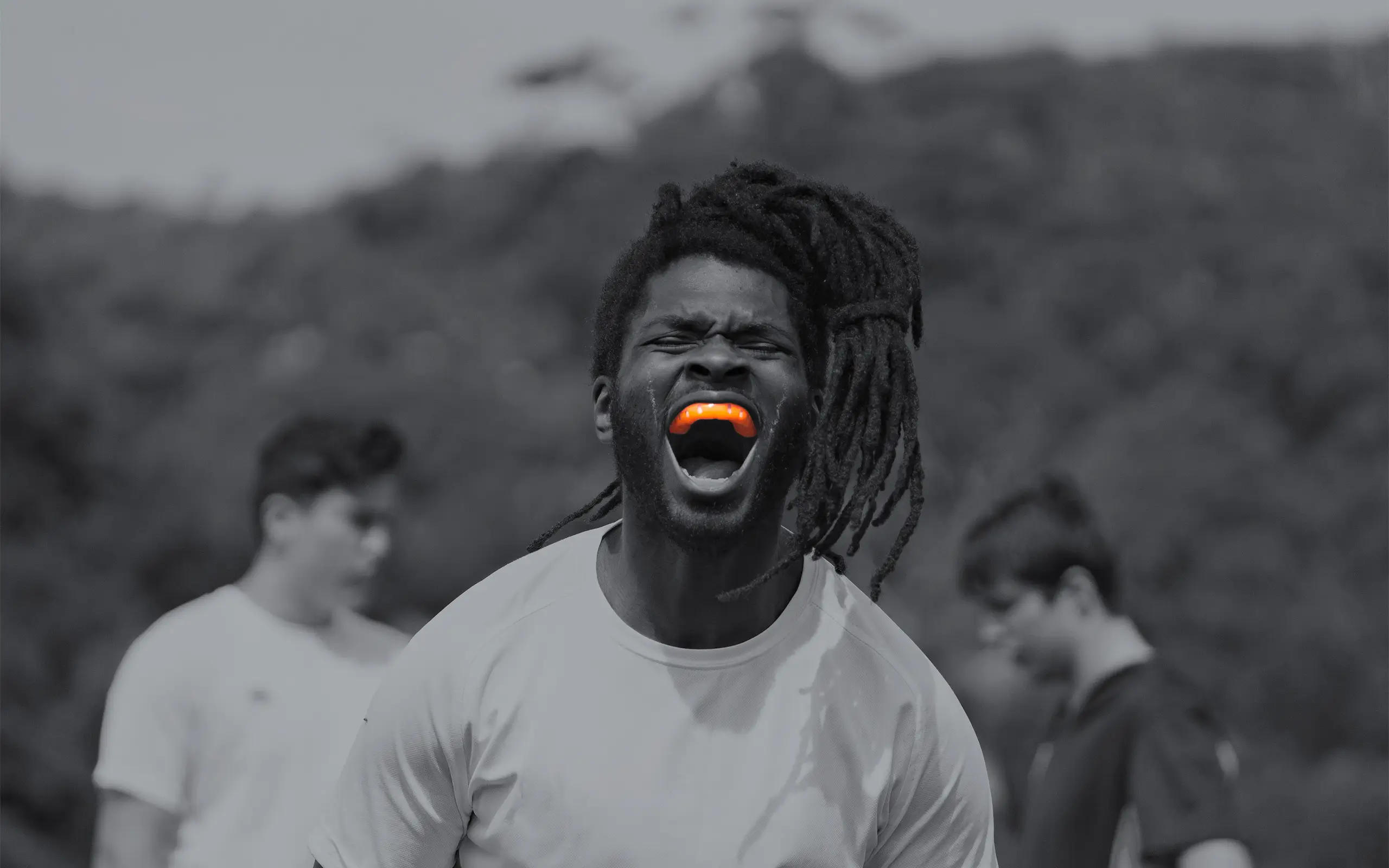 Triumphant male athlete with Neomorph Orange Mouthguard