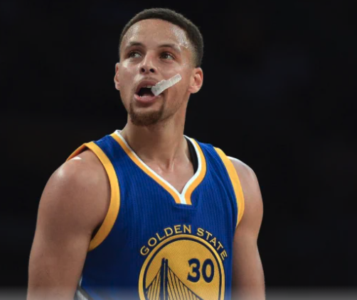 Stephen Curry with mouthguard hanging out of his mouth